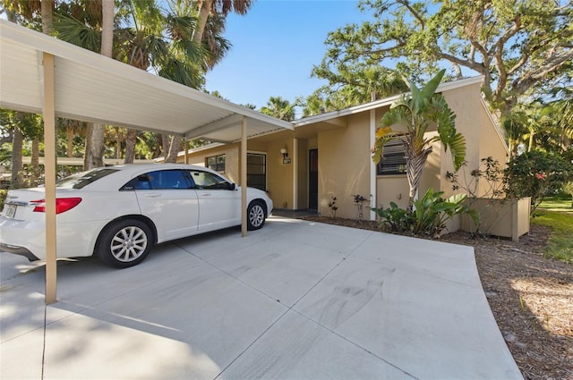 5071 Village Gardens Dr Unit 5, Sarasota, FL 34234 - view of front of property with stucco siding and a carport