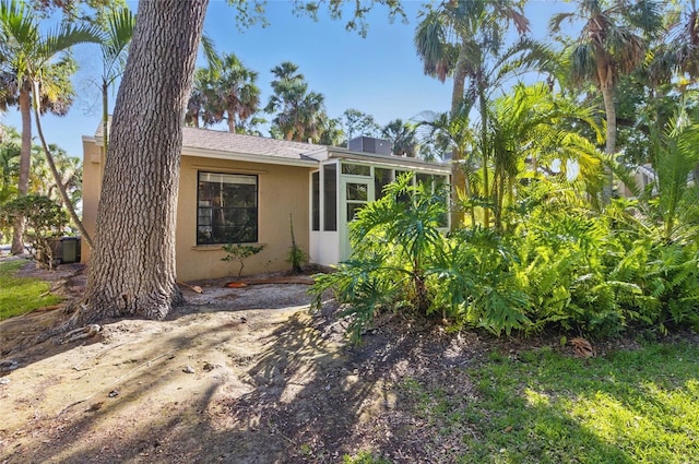 5071 Village Gardens Dr Unit 5, Sarasota, FL 34234 - view of front of property with stucco siding and a sunroom