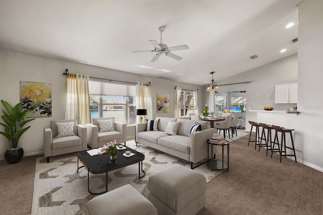 carpeted living room with lofted ceiling and ceiling fan