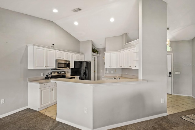 kitchen featuring appliances with stainless steel finishes, kitchen peninsula, light carpet, and white cabinets