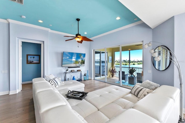 living room featuring wood-type flooring, crown molding, and ceiling fan