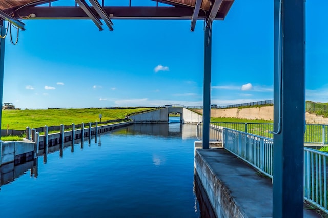 view of swimming pool featuring a boat dock and a water view