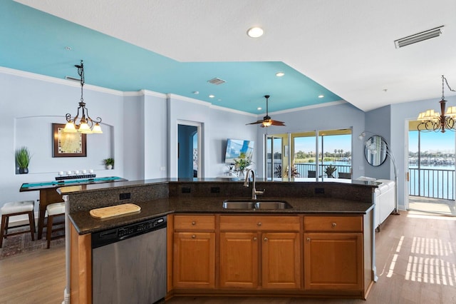 kitchen featuring light hardwood / wood-style flooring, an island with sink, sink, and stainless steel dishwasher