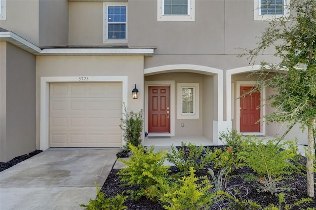 view of exterior entry with a garage