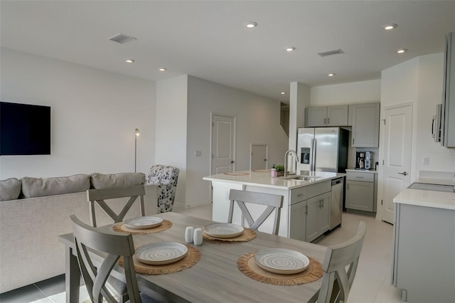 tiled dining area featuring sink