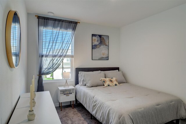 bedroom featuring dark colored carpet