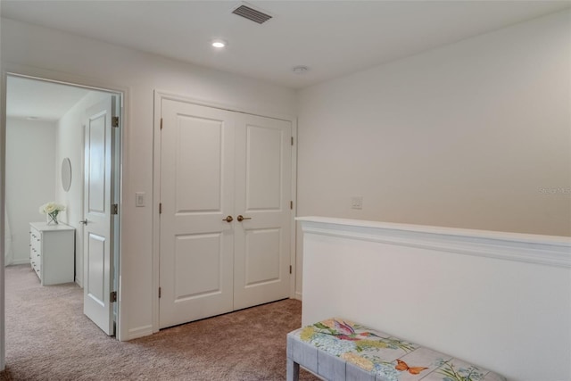 bedroom featuring a closet and light colored carpet