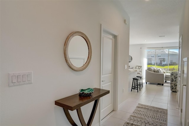 hall featuring light tile patterned floors