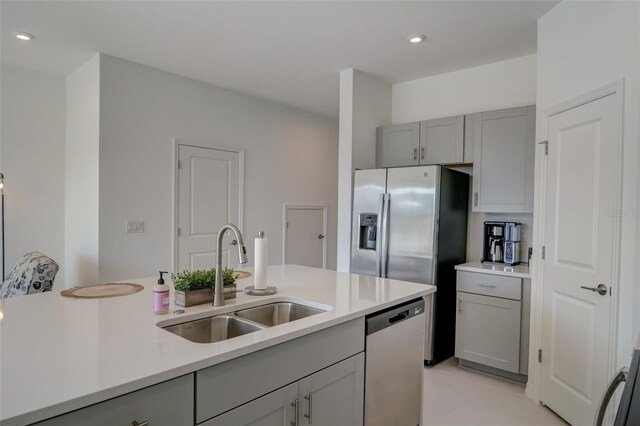 kitchen featuring gray cabinets, stainless steel appliances, and sink