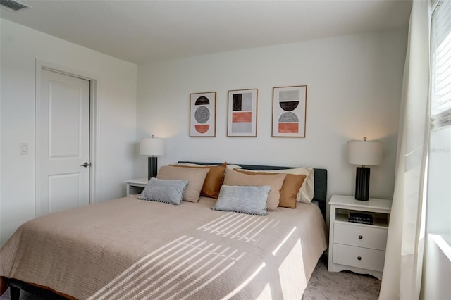 bedroom featuring light colored carpet