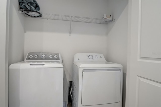 laundry room featuring washing machine and clothes dryer