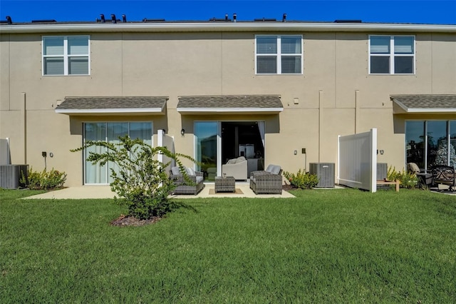 rear view of house with a lawn, outdoor lounge area, central AC, and a patio area