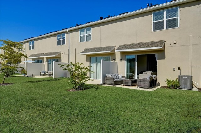 rear view of house with cooling unit, an outdoor living space, a patio area, and a yard