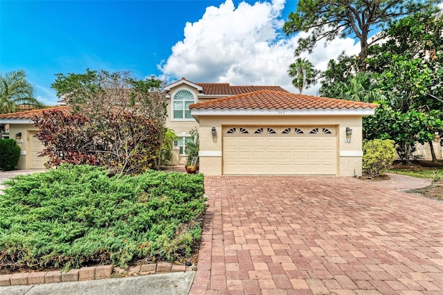 mediterranean / spanish-style home with a garage