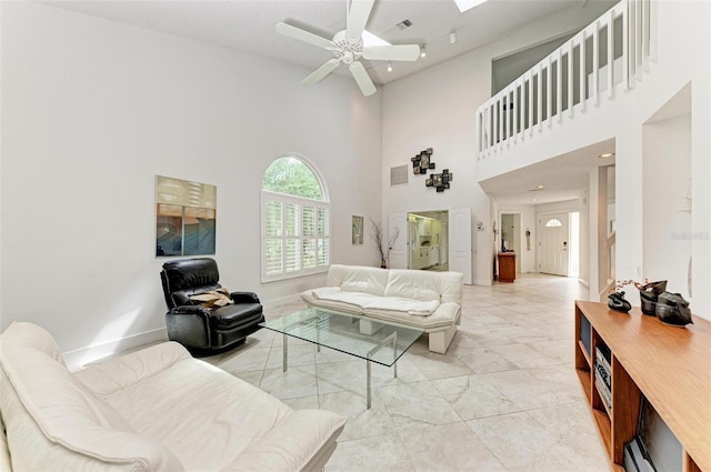 living room featuring a high ceiling and ceiling fan