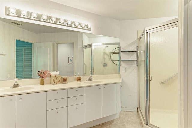 bathroom featuring tile patterned floors, vanity, and an enclosed shower