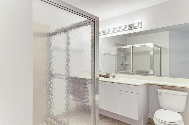 bathroom with vanity, a shower with shower door, and toilet