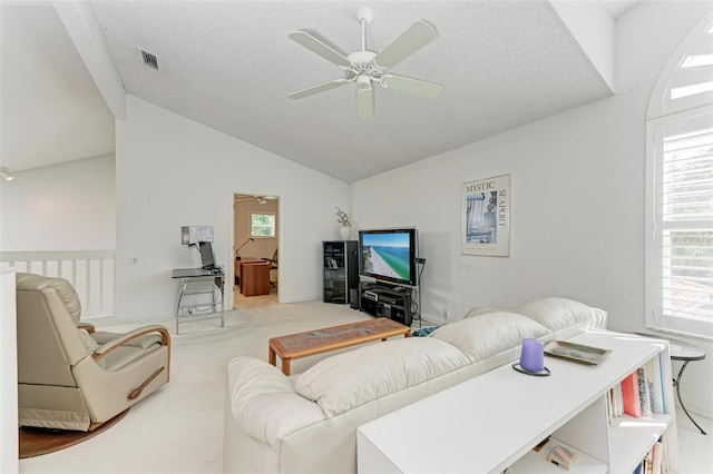 carpeted living room featuring ceiling fan, lofted ceiling, and a textured ceiling