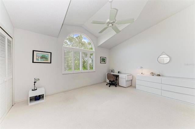 carpeted home office featuring ceiling fan and vaulted ceiling