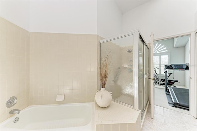 bathroom with tile patterned floors and independent shower and bath