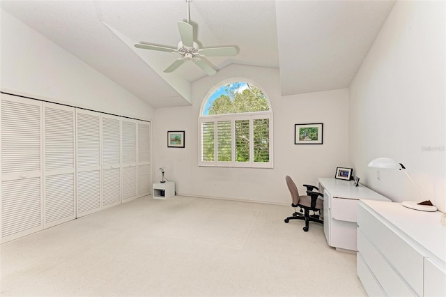 carpeted office with ceiling fan and vaulted ceiling