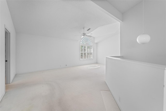 empty room with carpet floors, lofted ceiling, and a ceiling fan
