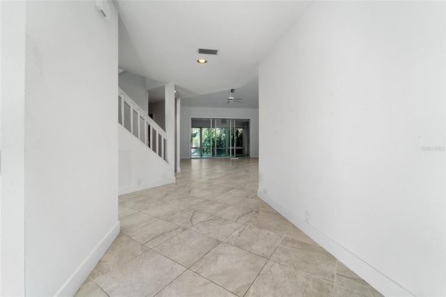 hallway with baseboards, stairs, and visible vents