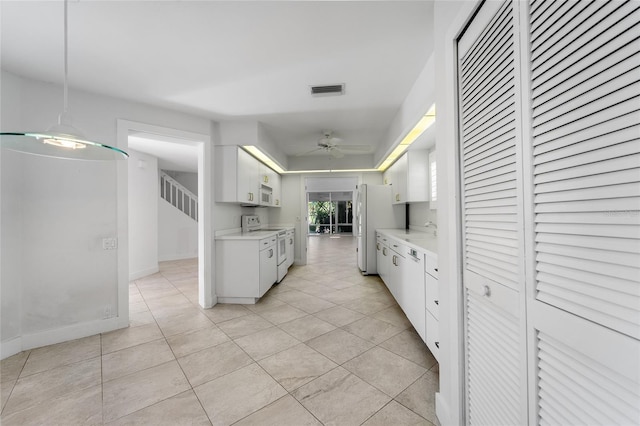 kitchen featuring a ceiling fan, light countertops, white cabinetry, and white appliances