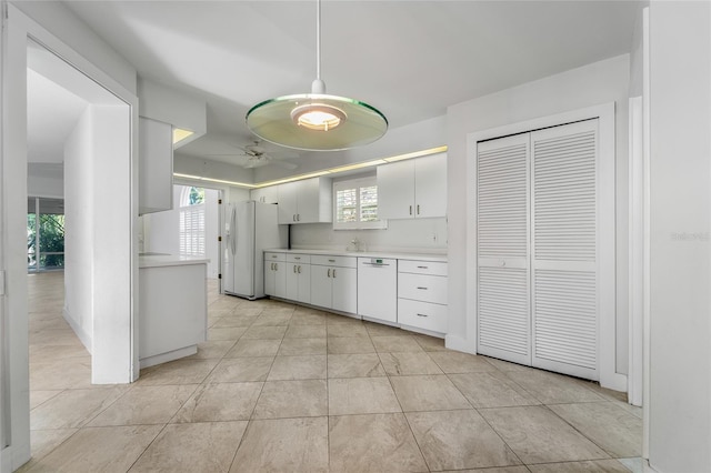 kitchen featuring white cabinetry, light countertops, a ceiling fan, and white appliances