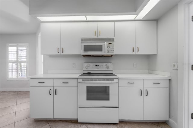 kitchen featuring white cabinetry, light countertops, and white appliances