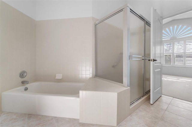 full bath with a bath, a stall shower, and tile patterned flooring