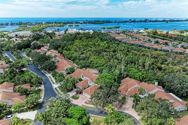 drone / aerial view with a water view and a residential view