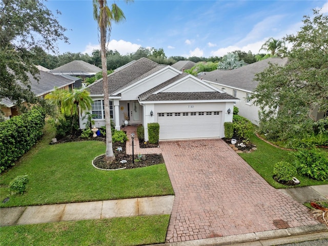 ranch-style house featuring a garage and a front lawn