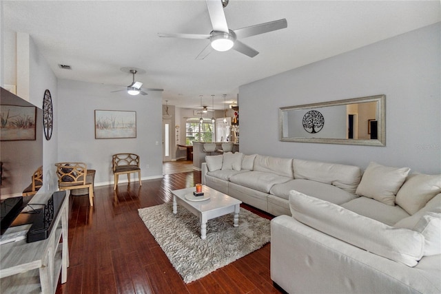 living room with dark hardwood / wood-style floors and ceiling fan