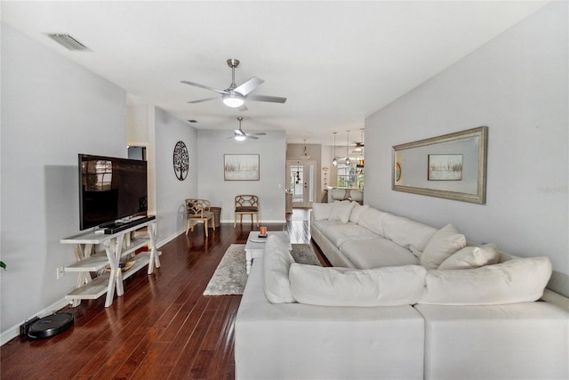 living room with ceiling fan and dark wood-type flooring