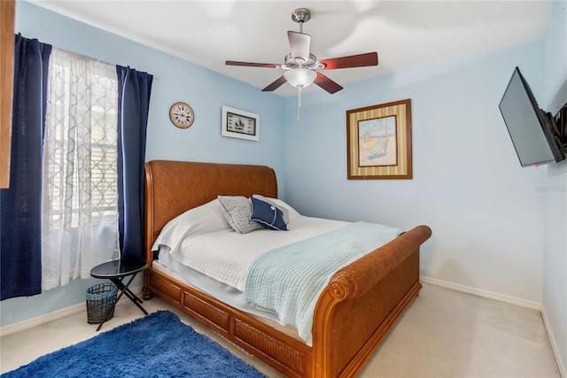 bedroom featuring ceiling fan and light carpet