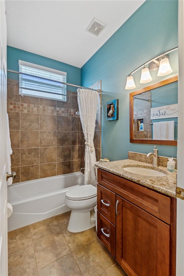 full bathroom with tile patterned flooring, vanity, toilet, and shower / bath combo with shower curtain