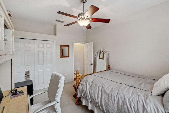 bedroom featuring ceiling fan, light colored carpet, and a closet