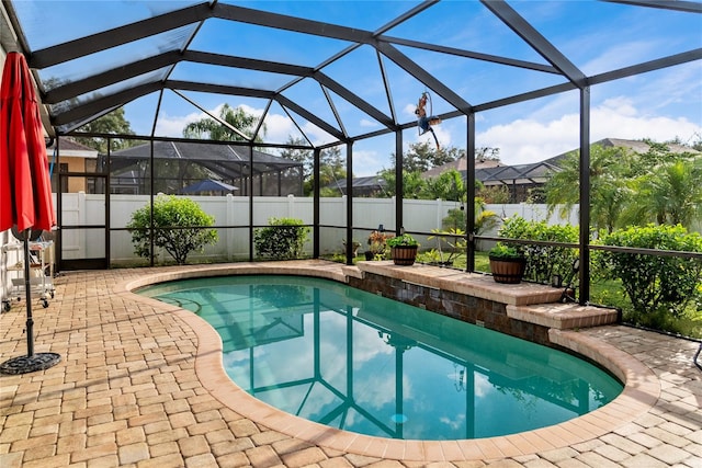 view of pool with a lanai and a patio area