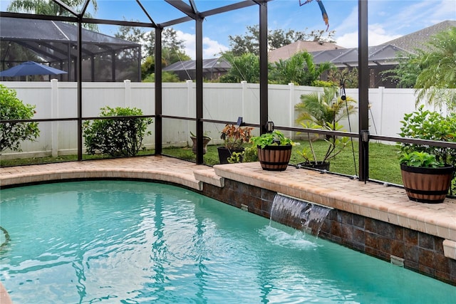 view of swimming pool featuring glass enclosure, a patio area, and pool water feature