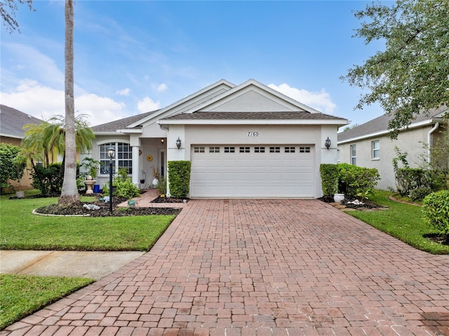 single story home featuring a front yard and a garage