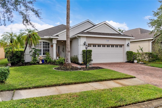 ranch-style house featuring a front lawn and a garage