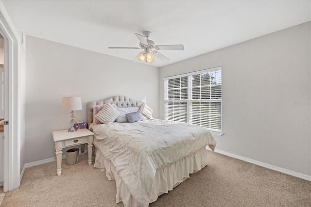 bedroom with ceiling fan and light colored carpet