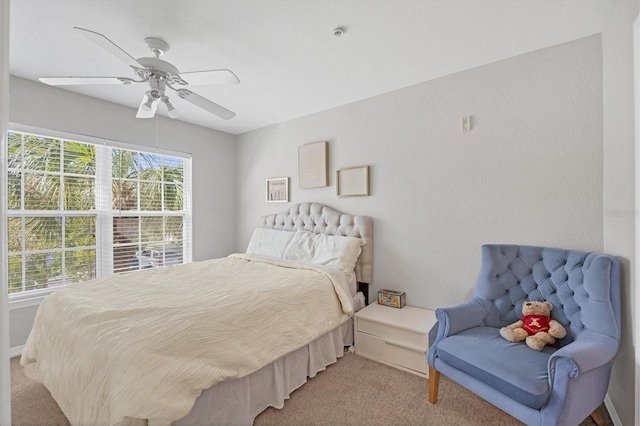 bedroom featuring light carpet and ceiling fan