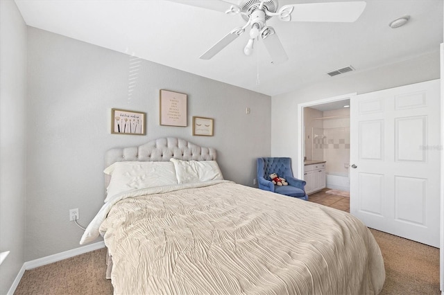 bedroom featuring connected bathroom, ceiling fan, and light colored carpet