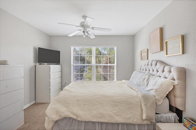 bedroom with ceiling fan and light colored carpet