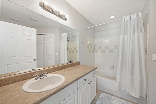 bathroom featuring shower / bathtub combination with curtain and vanity