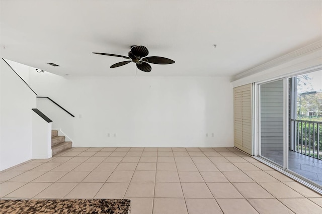 spare room featuring ceiling fan and light tile patterned flooring