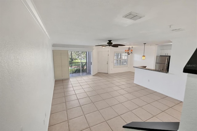 unfurnished living room featuring crown molding, light tile patterned floors, and ceiling fan