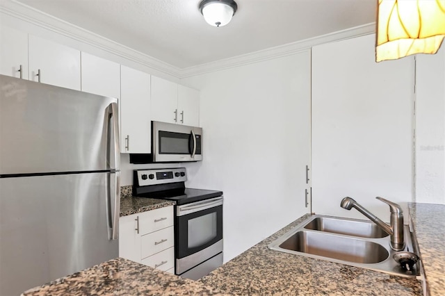 kitchen with appliances with stainless steel finishes, sink, dark stone counters, and white cabinets